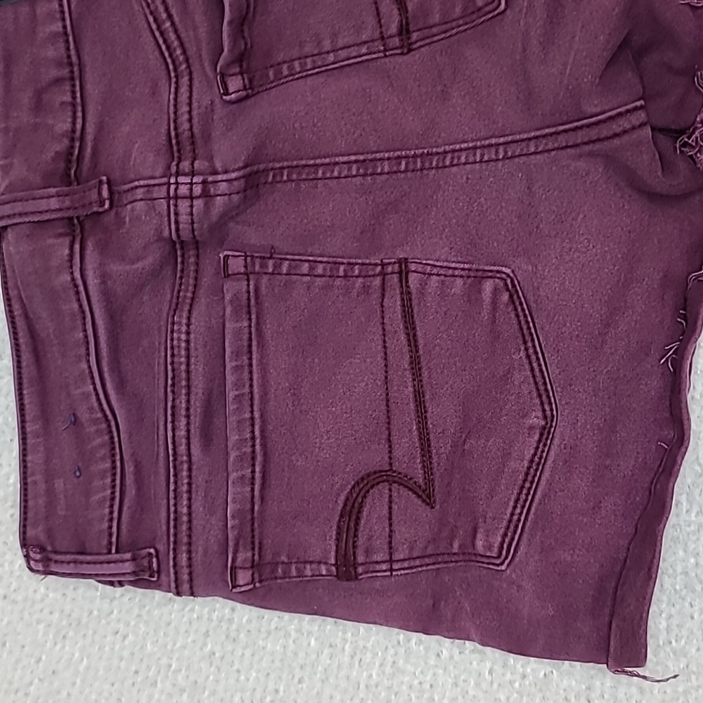 AE Next Level Low Rise Cuffed Raw Hem Cotton Denim Shortie Shorts in Burgundy - Picture 14 of 17